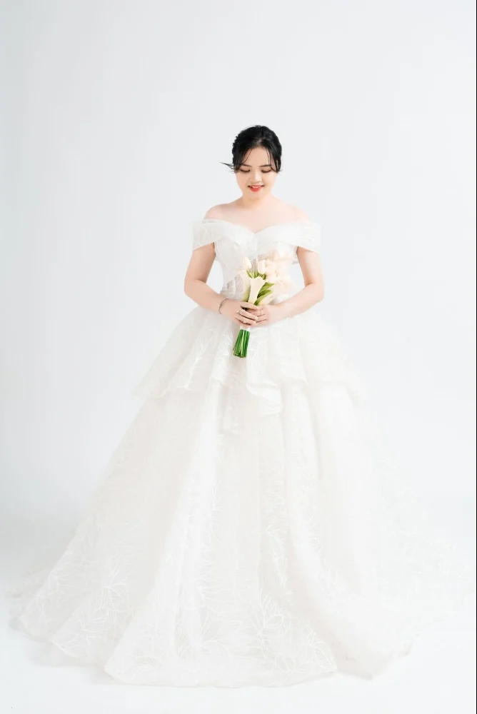 Bride in a white gown against a light background